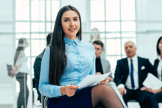 close up. female consultant against the background of a modern office. work with documents