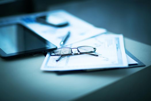 Business financial analysis of the workplace with the glasses on the documents in office
