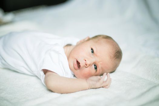 cute newborn baby waking up in the crib