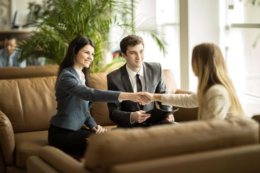 The lawyer of the company and the handshake of business partners after discussing a new contract in a modern office