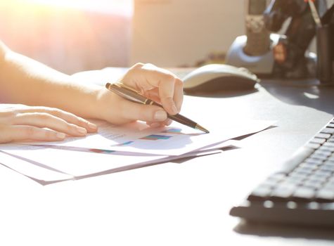 Business Woman Writing with pen in the office
