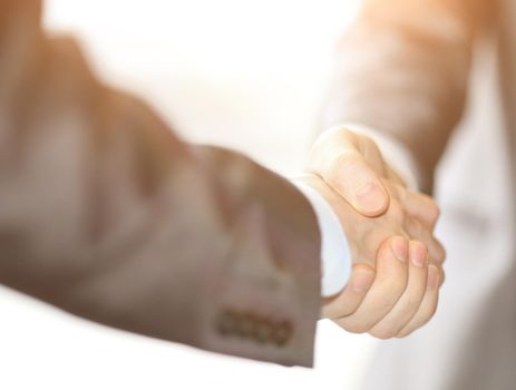 Closeup of a business hand shake between two colleagues