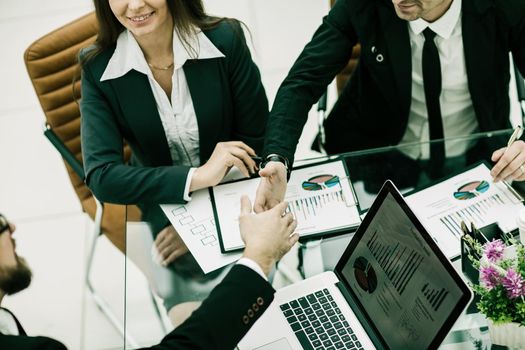 closeup of handshake of business partners in the workplace in the office