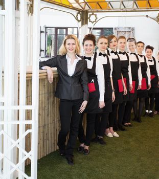 group of waiters at a prestigious restaurant standing in the column in the lobby of the restaurant