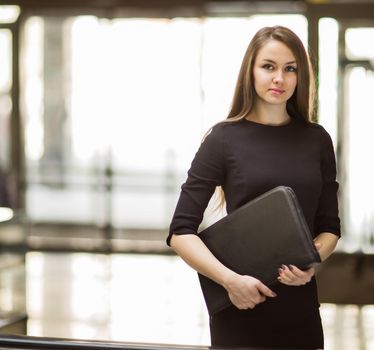 business woman with documents on the background of a spacious office.photo has empty space for your text