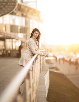 Portrait of a successful business woman on a modern office building background. The photo has an empty space for your text