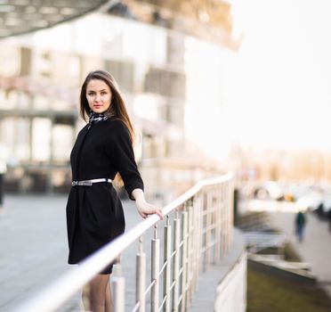 Newly-weds business woman on the background of an office building. The photo has an empty space for your text