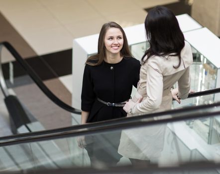 Manager and client standing on the stairs in the lobby of the office. The photo has an empty space for your text
