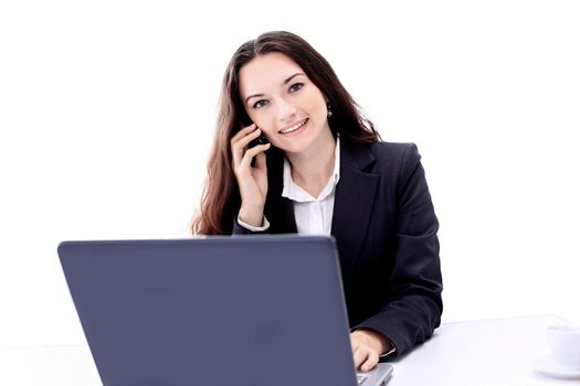 Thoughtful business woman in the office, the conversation on the phone, smiling.
