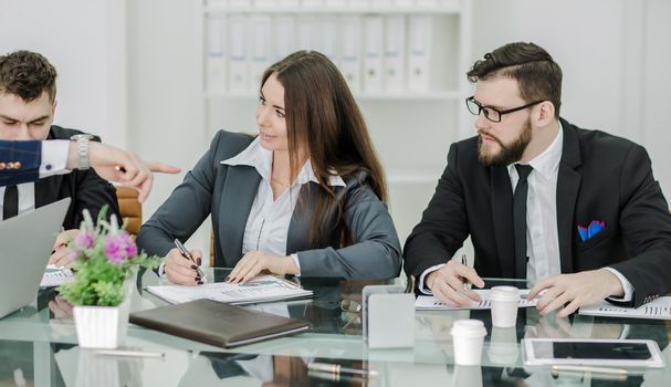 business team of professionals prepares a presentation of a new financial project.the photo has a empty space for your text