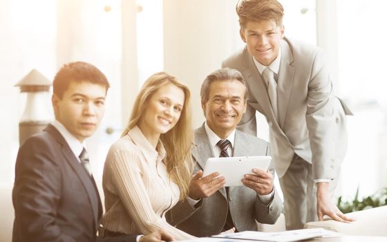 serious business team with tablet pc computers, documents having discussion in office