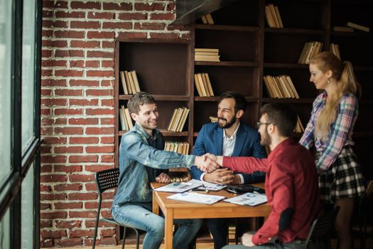 reliable business partners shake hands after discussing the contract for the work space in the office.the photo has a empty space for your text