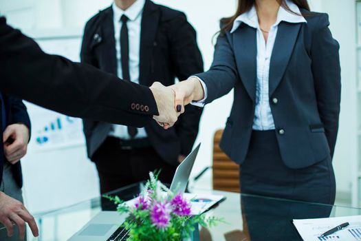 handshake business partners after discussion of the contract in the workplace in a modern office