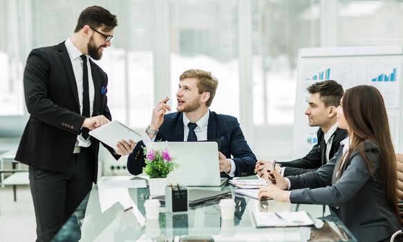 business partners discuss the profits before signing the contract in the workplace in a modern office.the photo has a empty space for your text