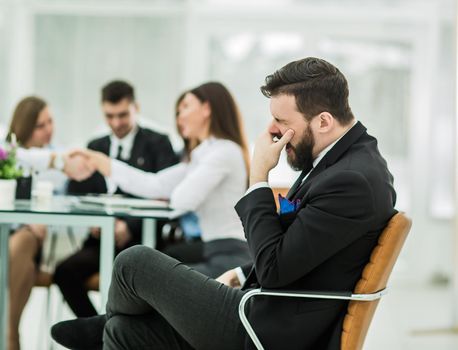 photo of the boss on the background of handshake of a Manager with a client in the workplace in a modern office.the photo has a empty space for your text