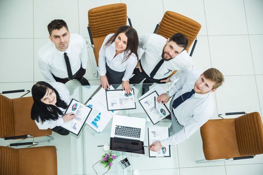top view is a professional business team developing a new financial strategy of the company at a work location in a modern office.