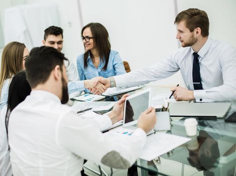 reliable handshake business partners after signing new contract in the workplace in the office.the photo has a empty space for your text