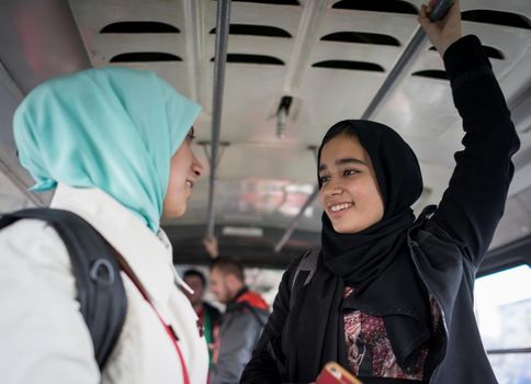 Mother and daughter riding public transport in the city