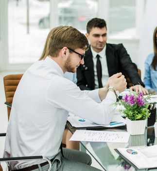 business team makes an analysis of the conditions of the new contract in the workplace in the office.the photo has a empty space for your text