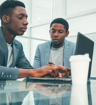 young employees using a laptop in the office. photo with copy-space