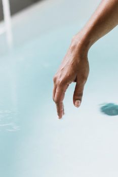 Isolated hand with copy space in blue water background. Concept of spa and relax.