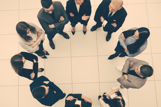 top view. group of business people standing in a circle. the concept of team building