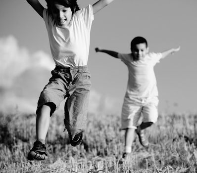 Two little kids on field running together