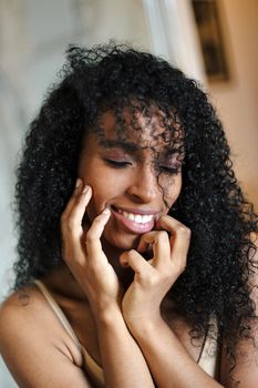 Close up portrait of black girl with curly hair. Concept of afro american beauty and female person.