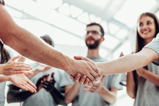 close up. handshake of two students on the background of the student team . photo with copy space