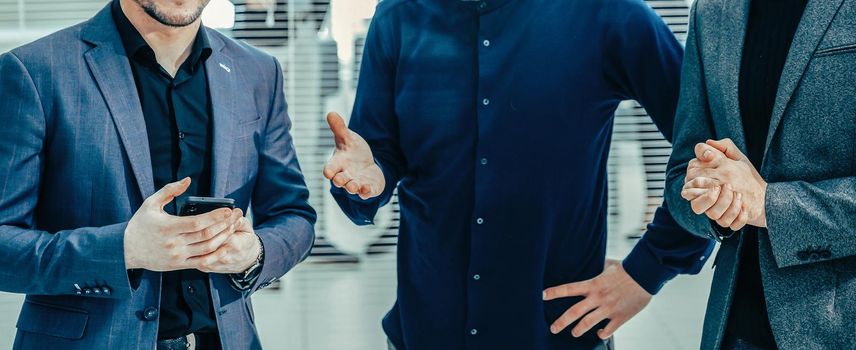 group of employees talking standing in the office. business concept.