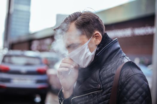 close up. casual man Smoking standing on the street. epidemic in the city