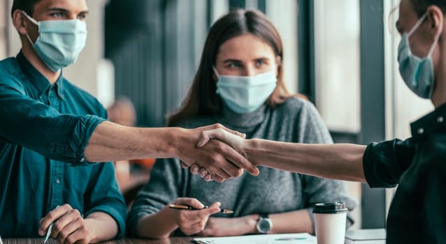 close up. business colleagues shaking hands with each other. office workdays .