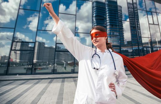 female doctor in a superhero Cape is ready to help . photo with a copy-space.