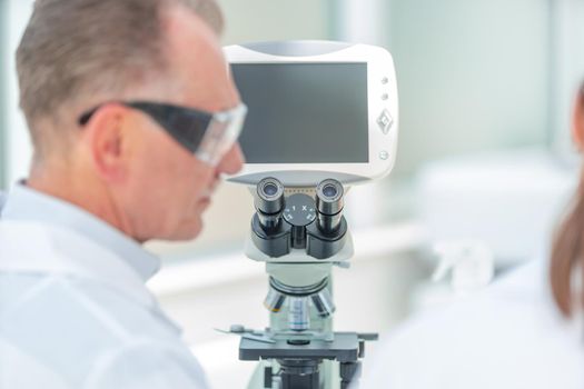 close up. a medical scientist sitting at a laboratory table. science and health.