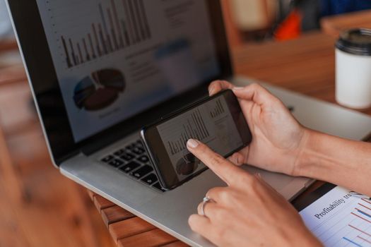 business woman using smartphone to analyze financial data. people and technology.