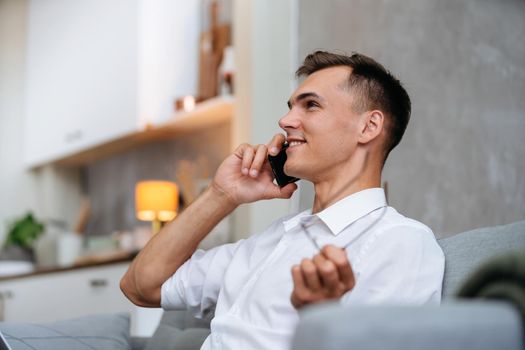 close up. attractive young man talking on a smartphone.