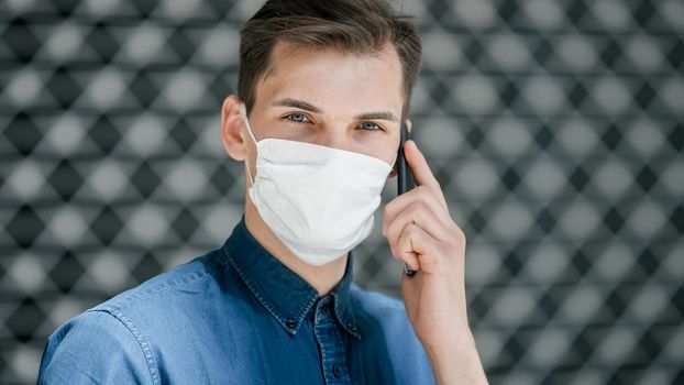 close up. a young man in a protective mask looking at you . photo with a copy-space