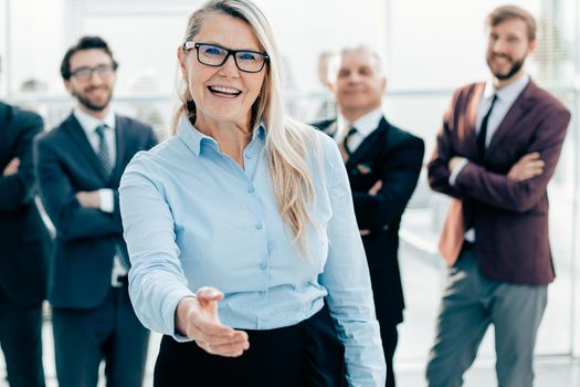 smiling business woman holding out her hand for a handshake. the concept of cooperation