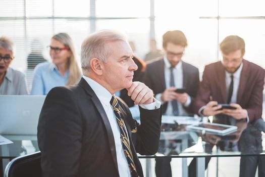 successful businessman sitting in front of an office Desk. business people