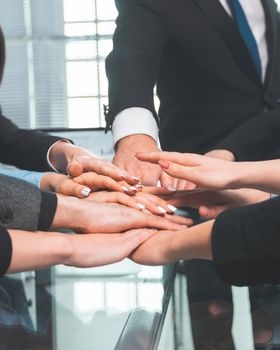 close up. business team showing their unity while sitting at the office table