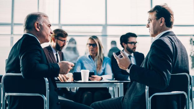 business colleagues discussing serious issues at an office meeting. business concept