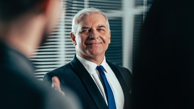 close up. successful businessman pointing to a flipchart with financial indicators