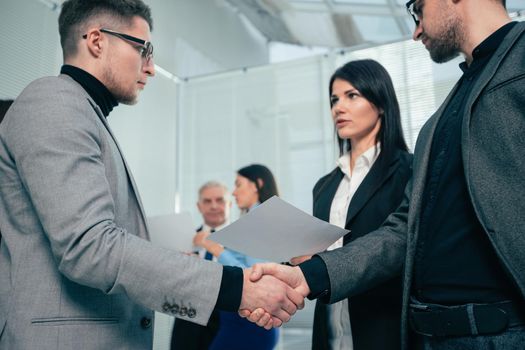 smiling business partners shaking hands with each other. the concept of cooperation