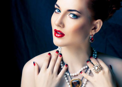 beauty rich woman with bright makeup wearing luxury jewellery on black background, fashion lady close up