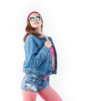 young pretty teenage hipster girl posing emotional happy smiling on white background, lifestyle people concept close up, wearing glasses close up