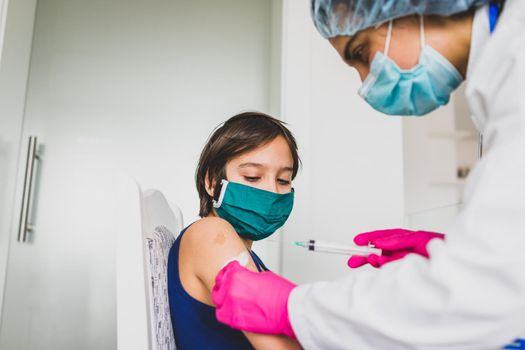 Little cute child with mask getting injection