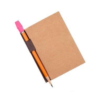 Closed pad with pencil in holder isolated on white. The plain brown pad has a blank cover with attached pencil holder tab.