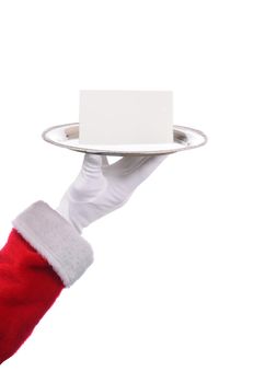 Santa Claus hand and arm silver serving tray and blank note. Closeup of arm with red suit sleeve and white gloved hand isolated on white.