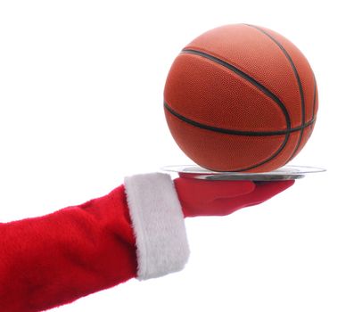 Santa Claus holding a serving tray with a basketball over a white background.