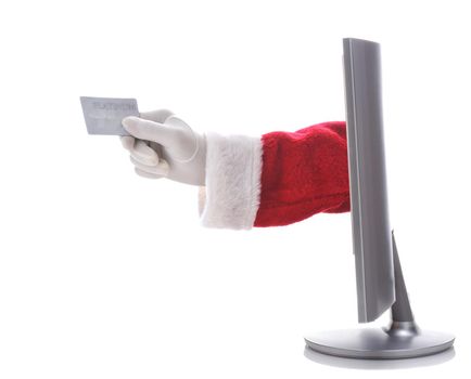 Santa Claus arm sticking through a computer screen holding a credit card representing e-commerce or on-line shopping. Horizontal format over white background.